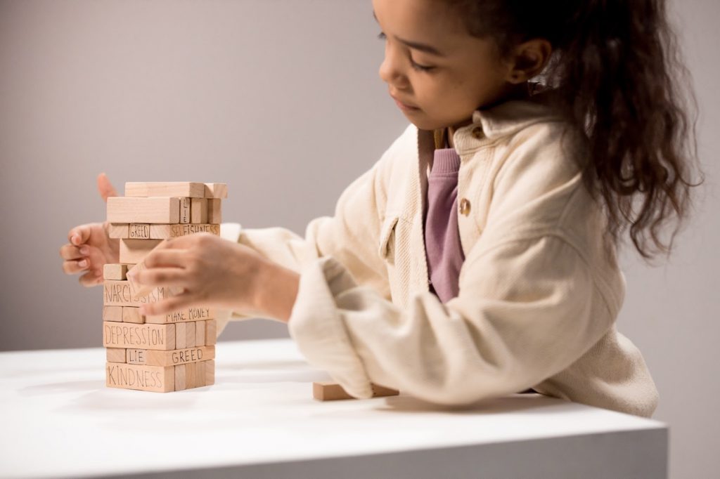 Young girl plays with building blocks