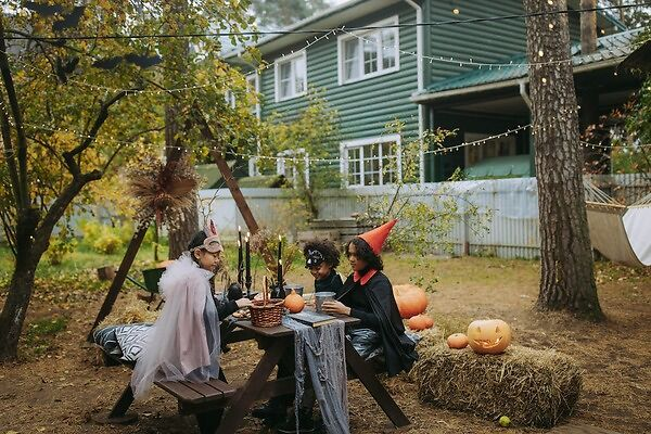Children in Halloween costumes enjoying candy