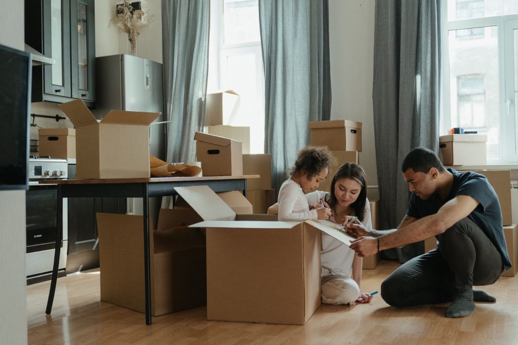 Family packing and writing something on a box