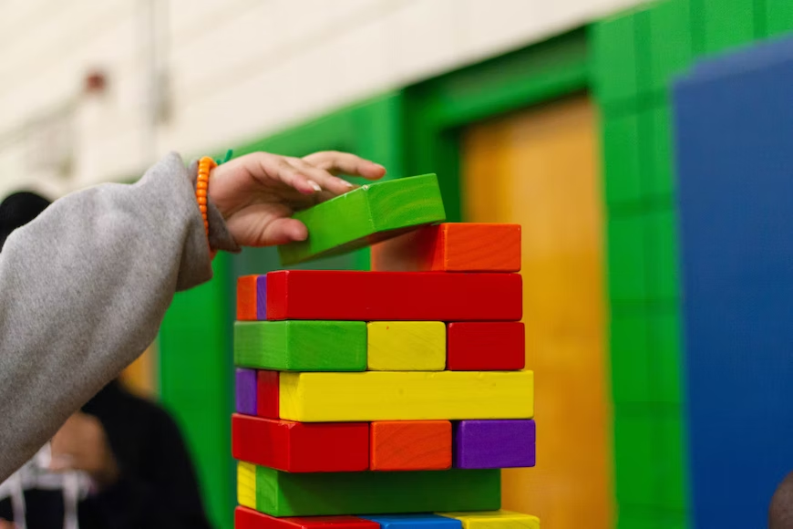 Small child playing with building blocks