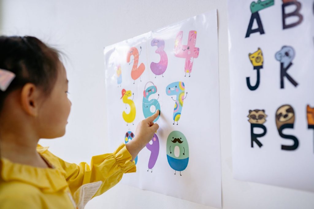 A child looking at numbers on a chart