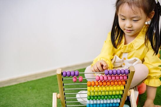 Young girl playing with abacus