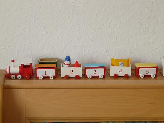 Wooden toy train on a shelf