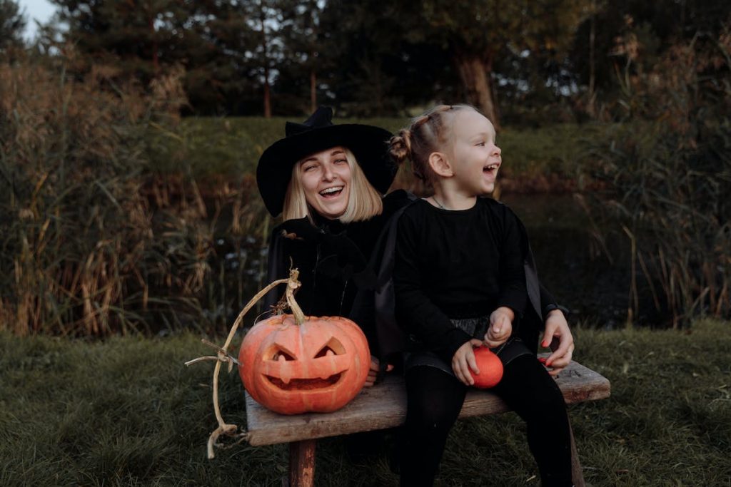 Mother and daughter in witch costumes for halloween