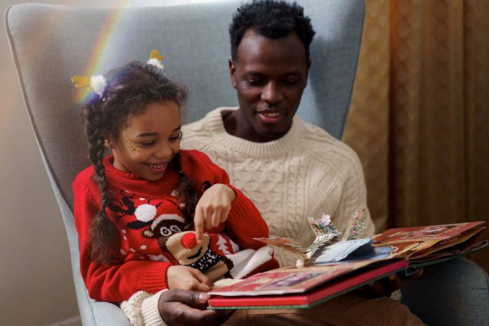 Father and daughter reading a fairy tale book