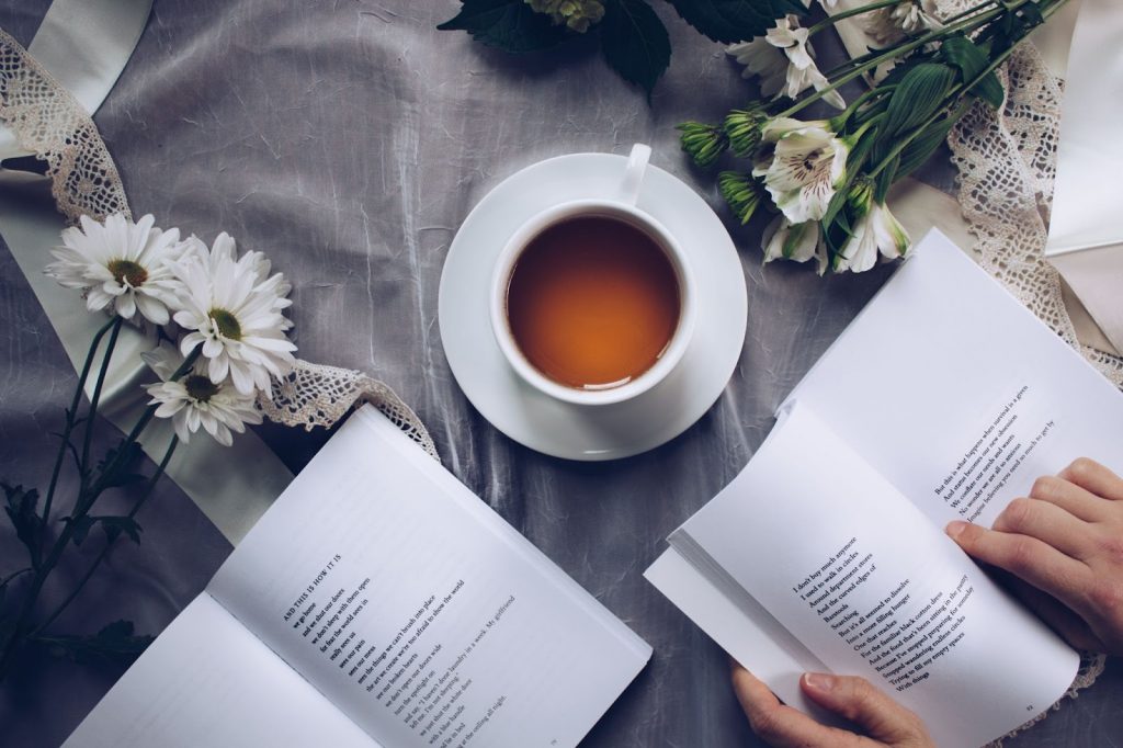 A white teacup and two open books