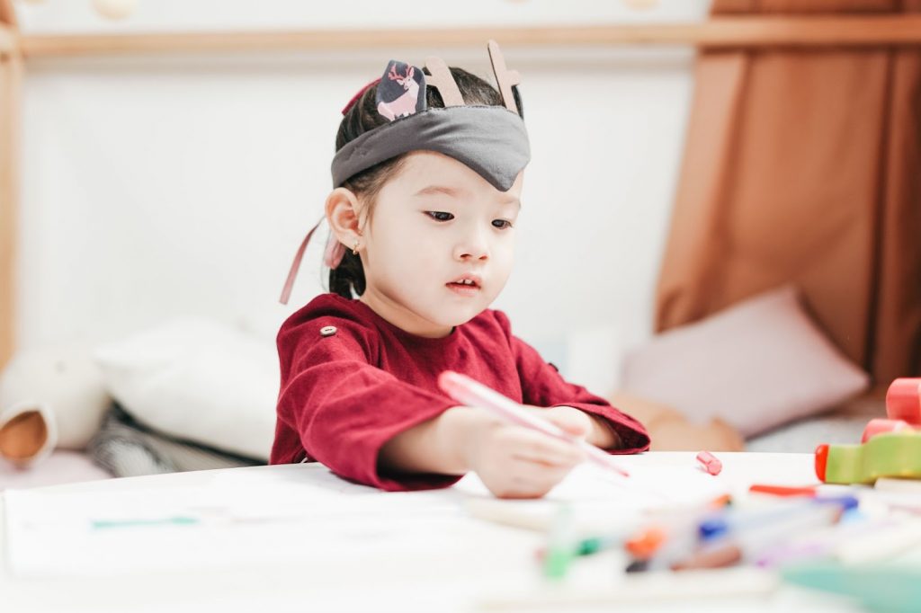 A little girl drawing something