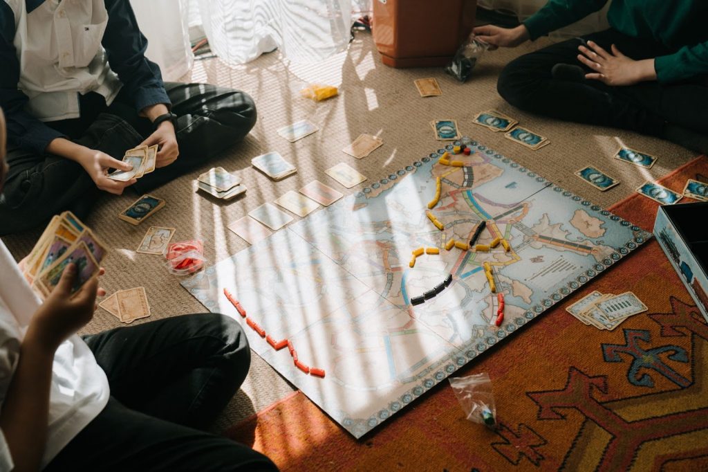 Family playing a board game together on the floor