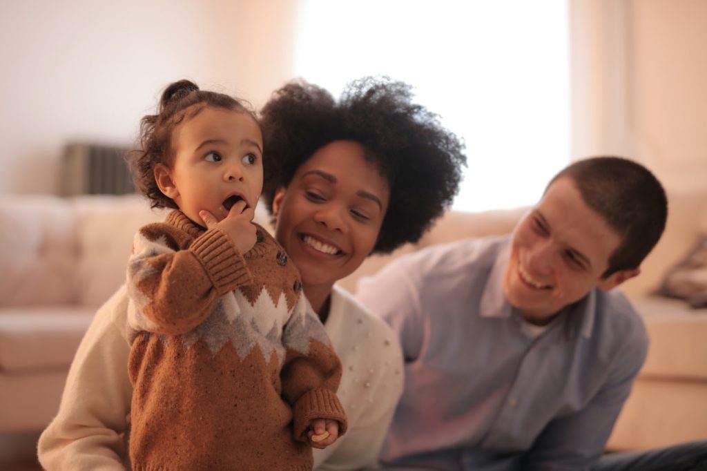 Young couple sitting with their toddler