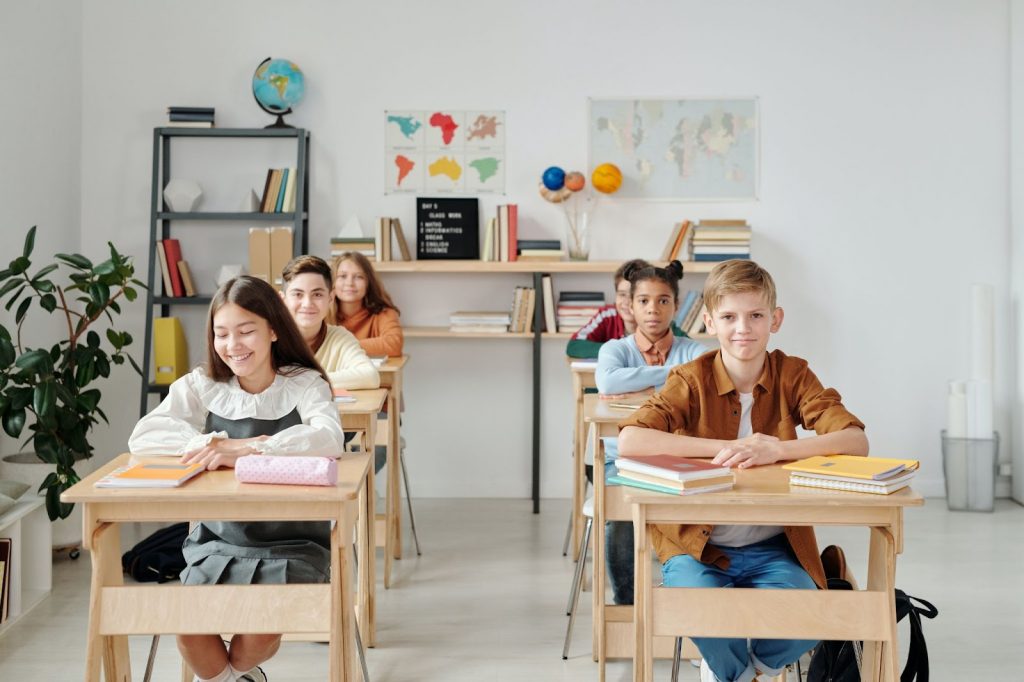 Children sitting and smiling in a classroom