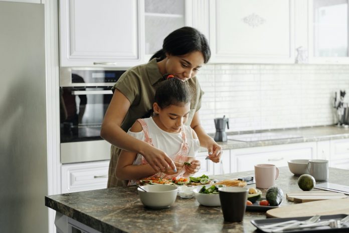 A girl looking with her mother