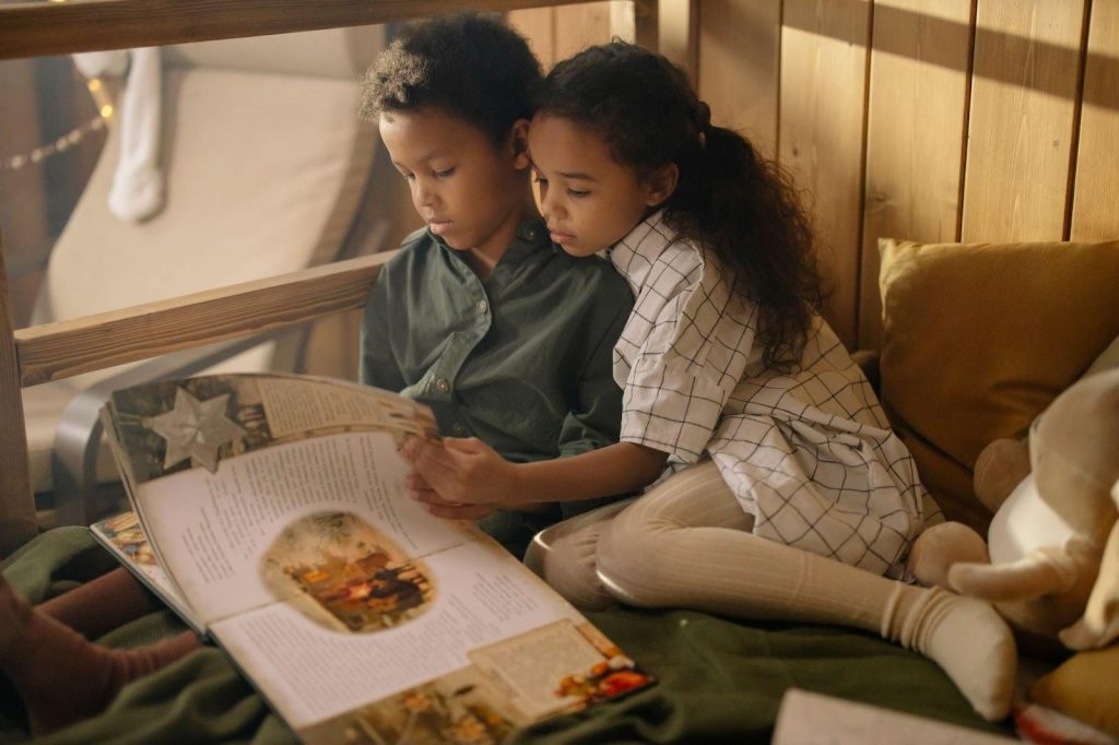 Two kids reading a fairy tale book