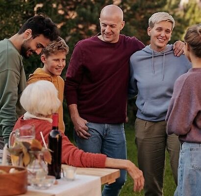 A group of people talking in a park