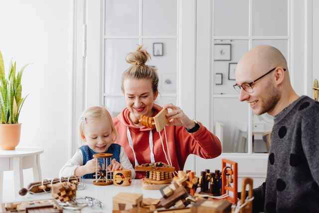 Parents playing educational games with child