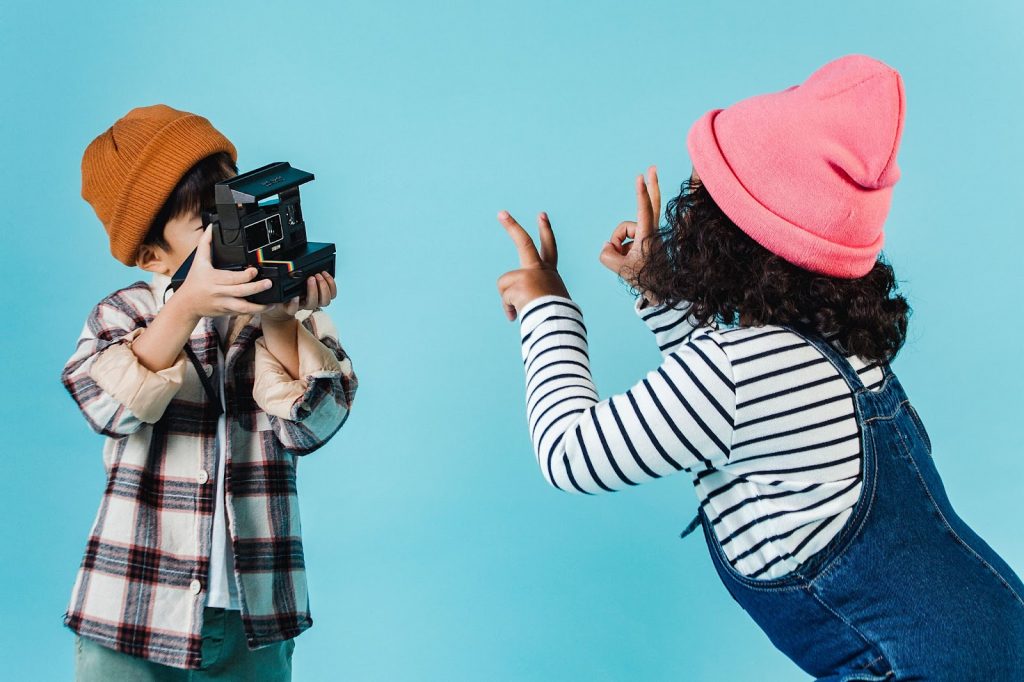 Children taking photos on an instant camera