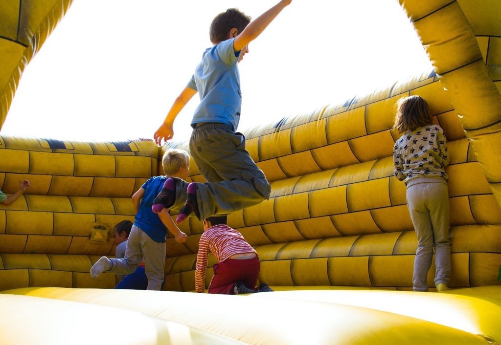 Young kids playing and jumping in bouncy house