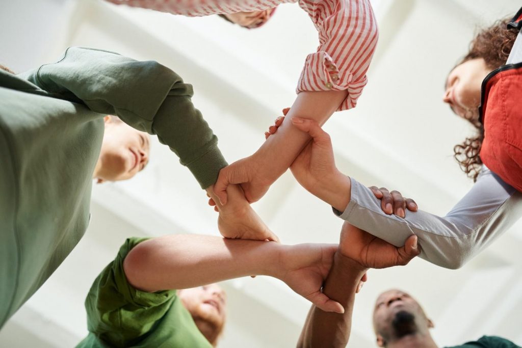 Five people holding hands