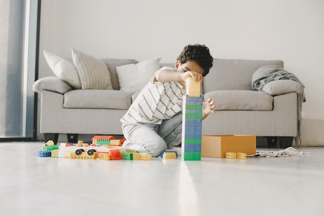 A boy building a tower with blocks