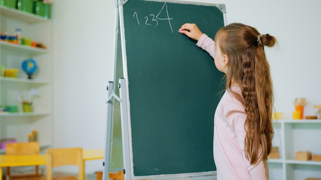 Girl writing out sequence of natural numbers