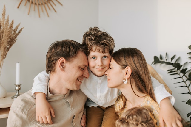 A child hugging his parents