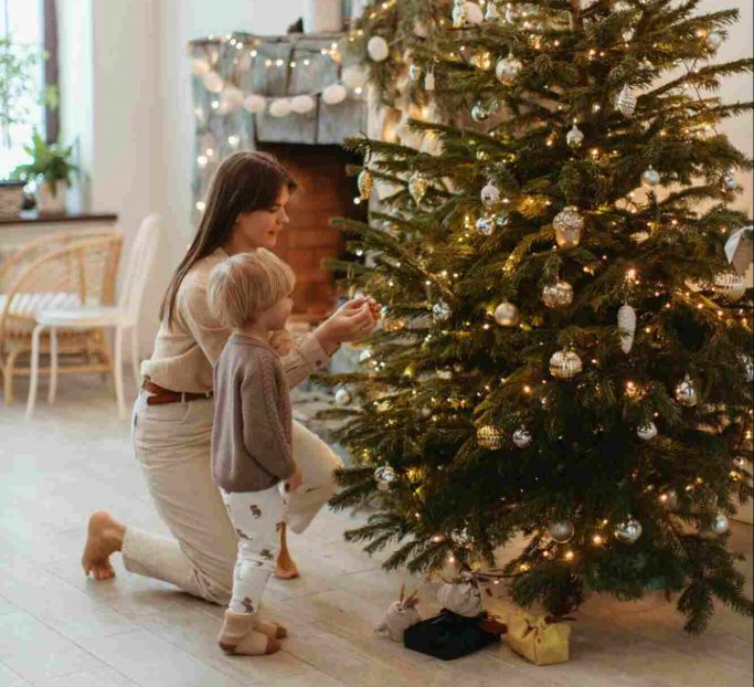 Image of a mother and son decorating Christmas tree together