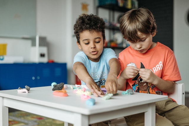 Two boys playing with playdough