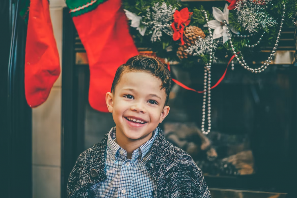 A child laughing with Christmas decoration