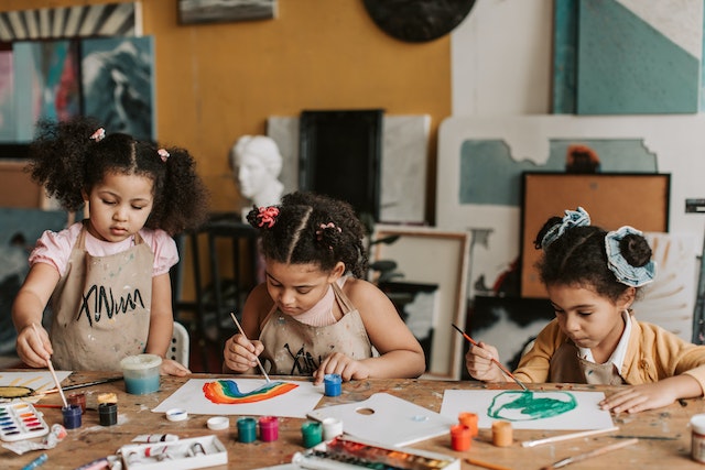 Three children in art class