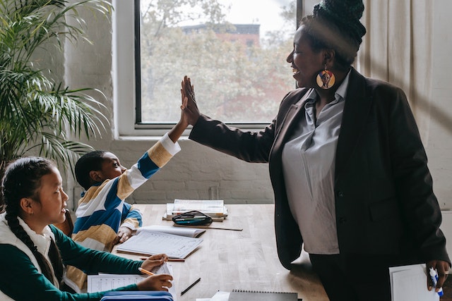 Teacher high fiving a student