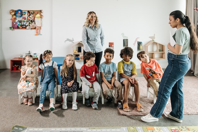 Kids lining up in chairs for an activity