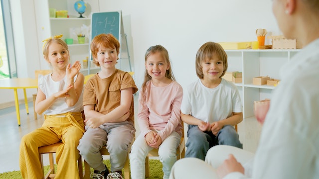 Kids listening to their teacher in a classroom