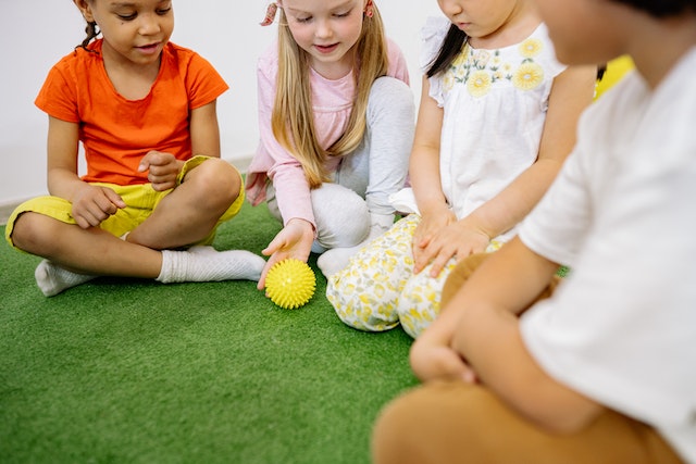 Children tossing a ball in a classroom activity