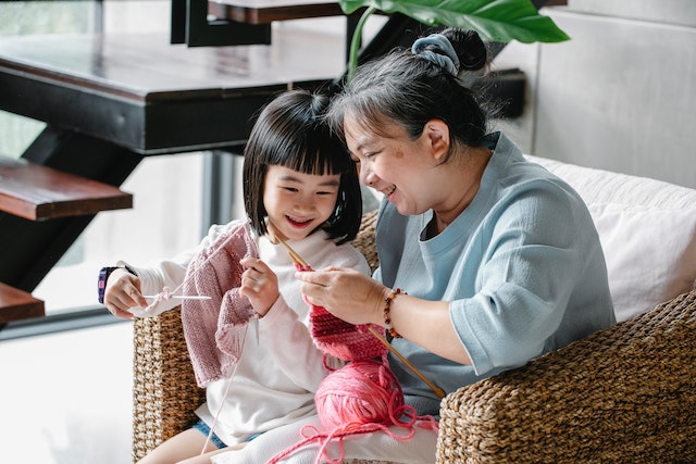 Grandmother and child knitting