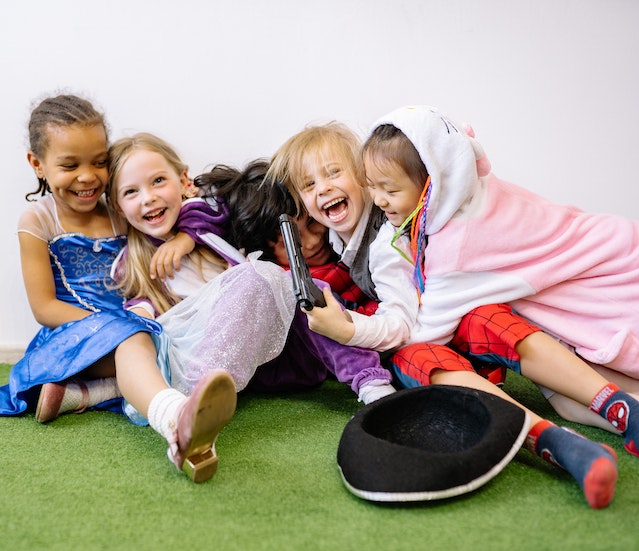 Kids in costumes laughing and playing