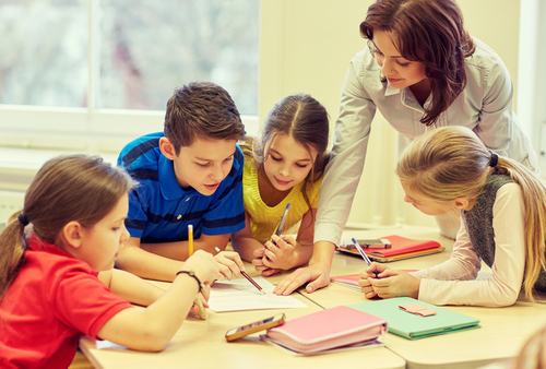 Woman teaching group of students sitting around a table