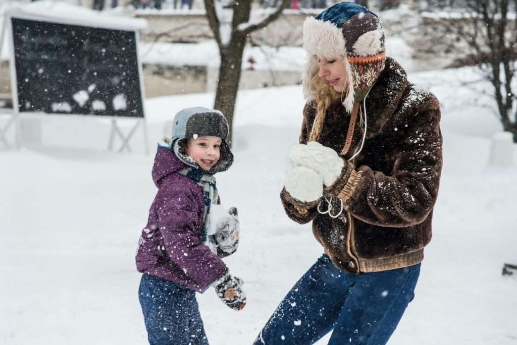 Woman and child playing in the snow