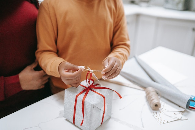 Mother and child wrapping a Mother’s Day craft gift