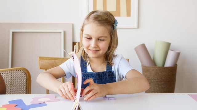 Child expressing happiness through arts and crafts