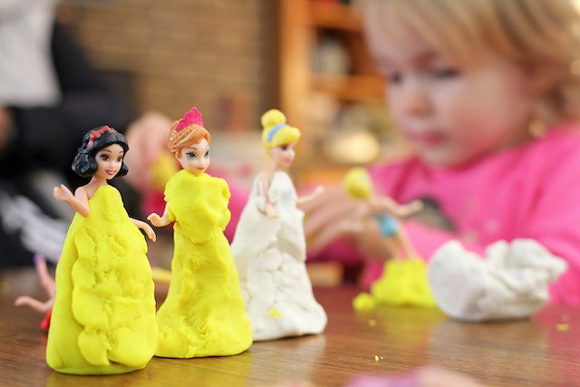 Child in sensory play with dolls