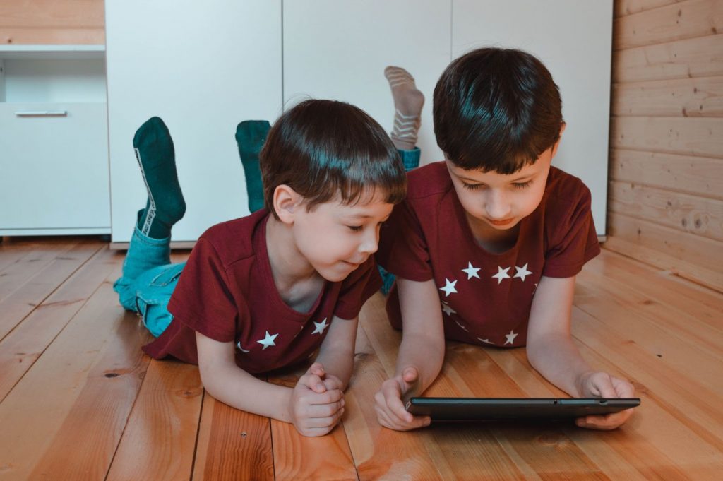 Cute siblings using tablet together at home