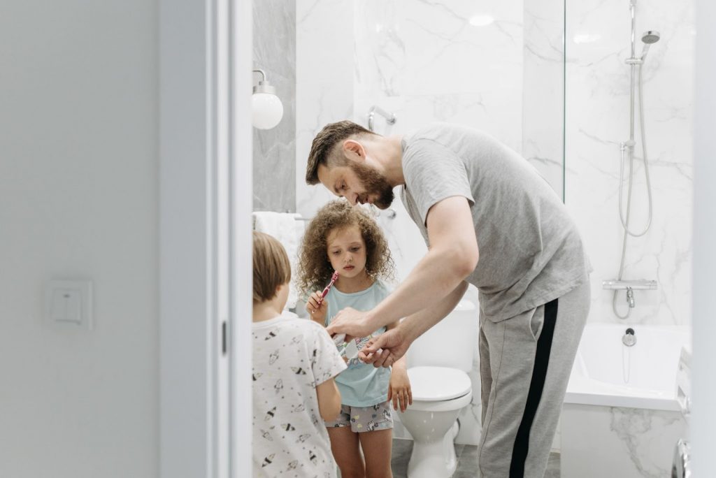 Father teaching kids personal hygiene