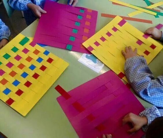 Kids weaving paper in art class