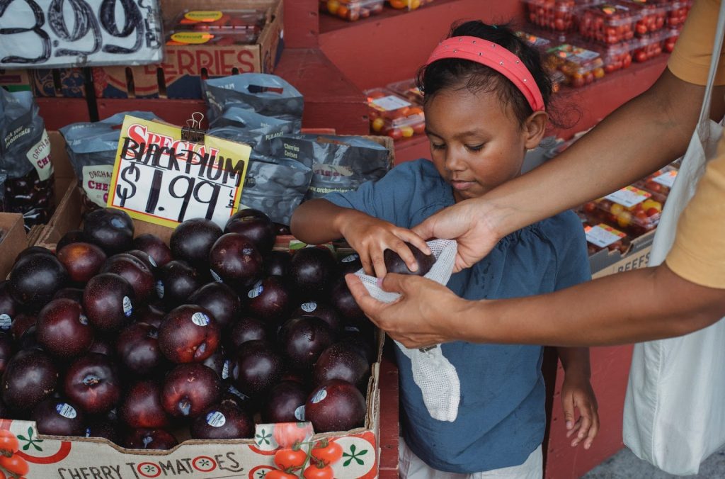 Mother teaching daughter to shop properly