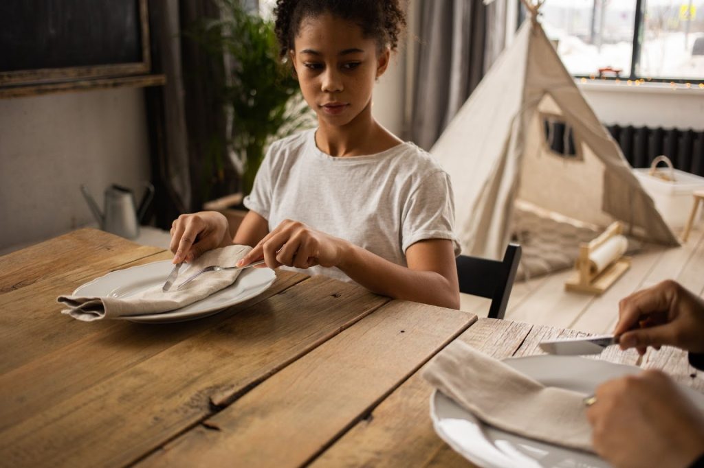 Girl learning table manners