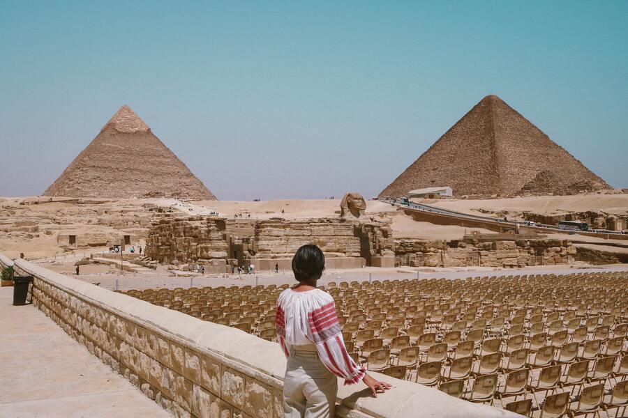 A woman looking at pyramids from far