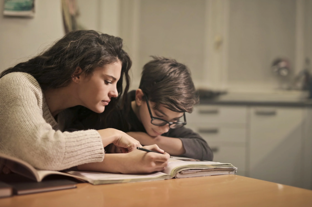 A mother teaches her son in the kitchen