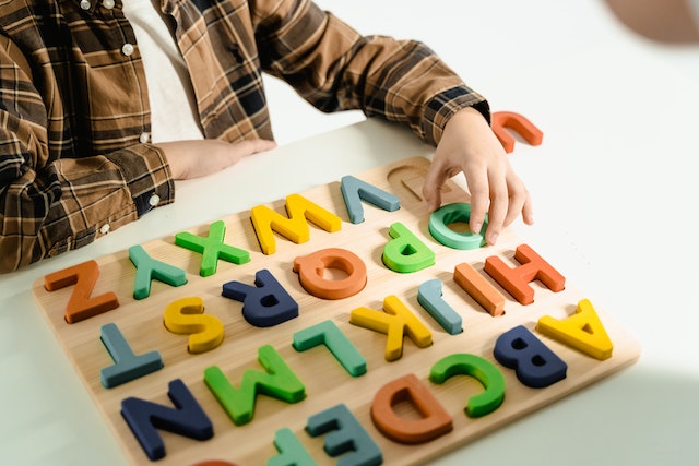 Child playing with alphabet toys