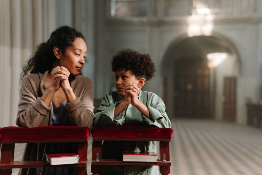 Mother and Daughter Praying in the Church