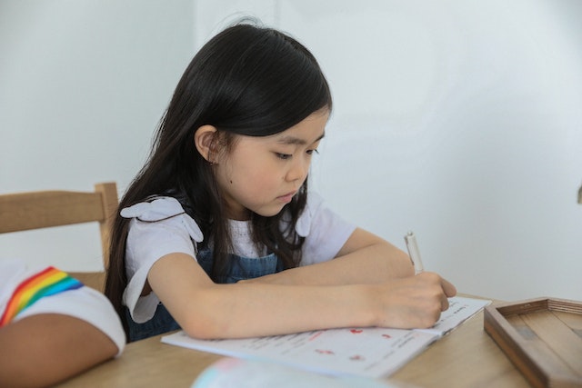 Child focusing on kindergarten educational material