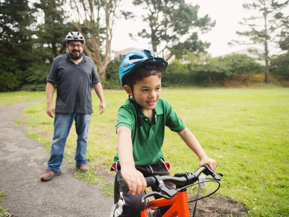 Father teaching his son cycling
